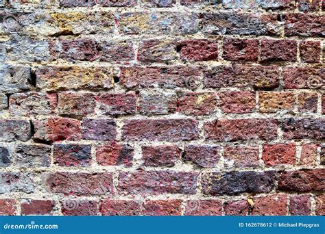 Detailed Close Up View On An Aged And Weathered Red Bricks Wall In High