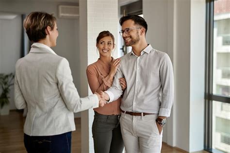 Pareja Feliz Comprando Una Casa Nueva Y Estrechando La Mano Con Su