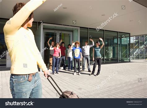 Youthful Group Waving Goodbye Young Man Stock Photo 1586663737