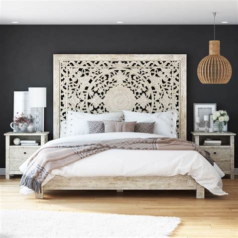 A Bedroom With Black Walls And White Bedding Wooden Headboard And