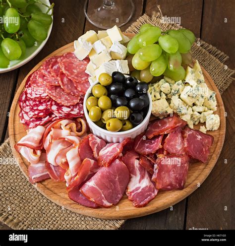 Antipasto catering platter with bacon, jerky, salami, cheese and grapes ...