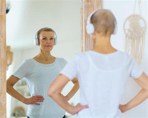 Premium Photo Mature Blonde Woman With Shot Hair Admires Reflection