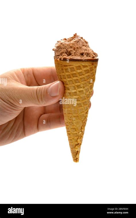 Hand Holding A Chocolate Flavor Ice Cream Cone With Couple Of Bites On