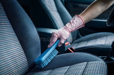 Pink Gloved Hand Brushes Blue Upholstery With Checkered Pattern In Car