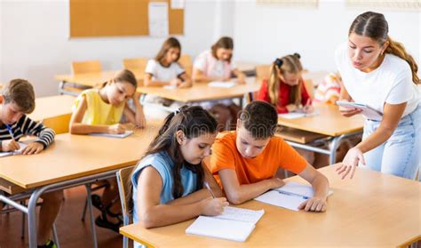 Tween Boy Peeking At Workbook Of Girl Classmate At Lesson Stock Image Image Of Portrait