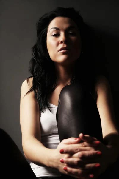 Beautiful Brunette With Big Breasts In A Blue Dress On A Black Background Stock Photo