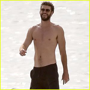 Liam Hemsworth Goes Shirtless On The Beach Where He Met Miley Cyrus