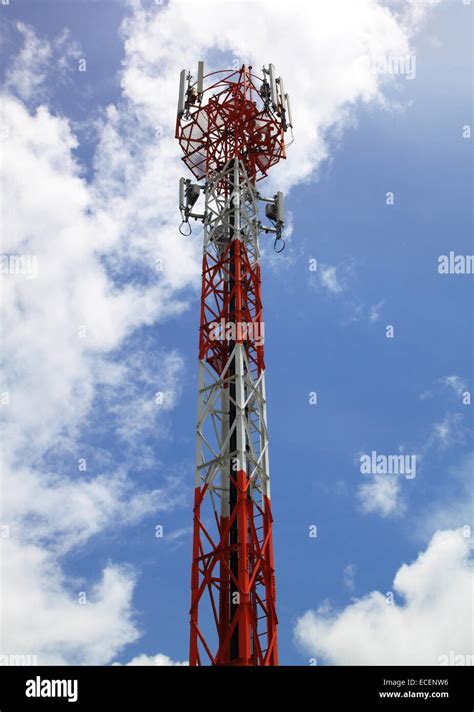 Three Tall Telecommunication Towers With Antennas On Blue Sky View