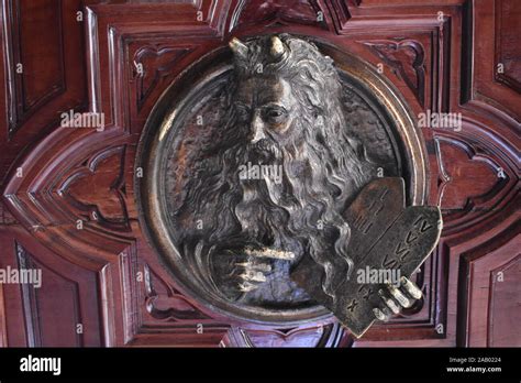 A sculpted bronze depiction of Moses with horns on the doors of the ...