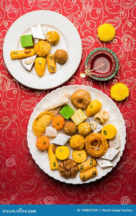 Indian Sweets Or Mithai For Diwali Festival With Oil Lamp Or Diya And