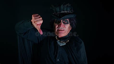 Sinister Senior Old Man In Costume Of Halloween Witcher Showing Thumbs