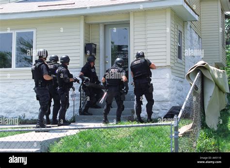 Police Swat Tac Team Entering Suspects Residence To Serve Search Stock