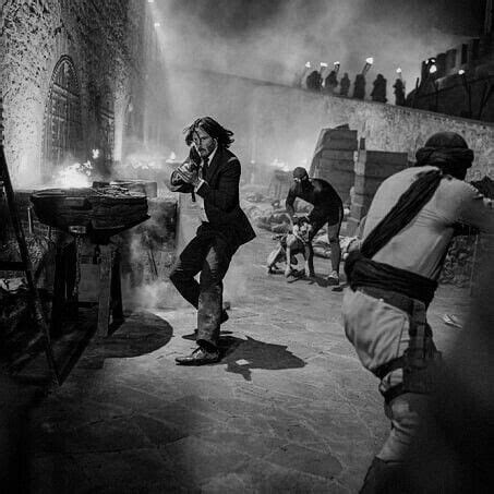 Black And White Photograph Of Man On Skateboard In Front Of Fire