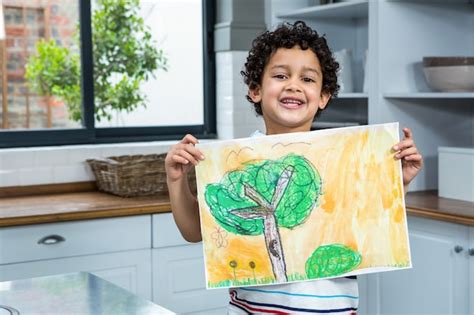 Premium Photo Cute Child Showing A Drawing