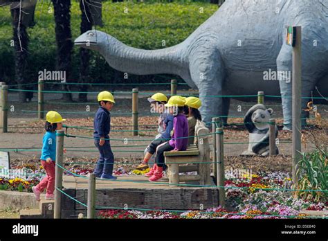 Children Playing At Hamura Zoo Life Size Dinosaurs Sculpture Background