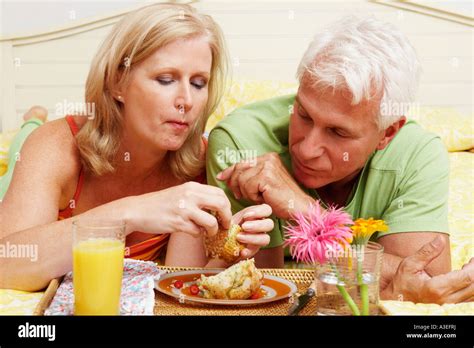 Close Up Of A Mature Couple Having Breakfast In Bed Stock Photo Alamy