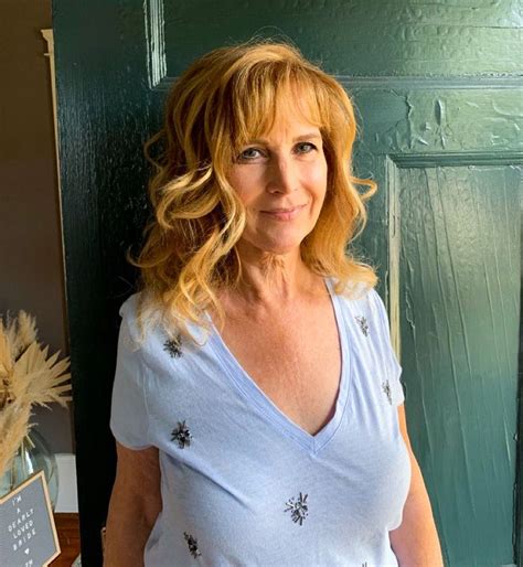 A Woman Standing In Front Of A Green Door