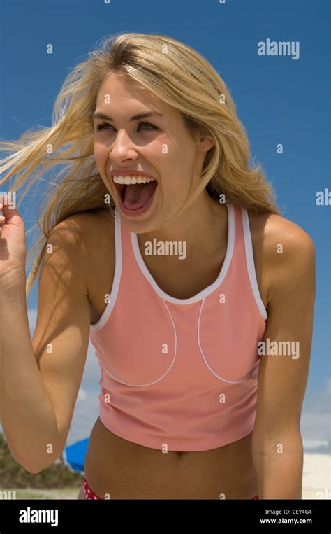 Female Very Long Blonde Hair Wearing Pink And White Cropped Vest Top