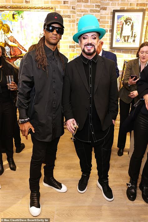 Boy George Showcases His Quirky Style In A Black Jacket And Bright Blue