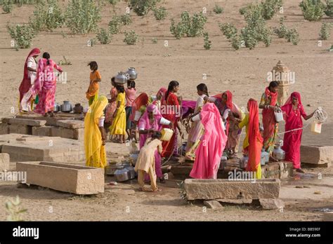 India Rajasthan Masuria Women And Girls Carrying Water From The Well Back To The Village Stock