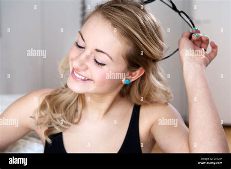 Woman Taking Off Her Glasses Stock Photo Alamy