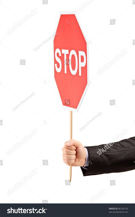 Hand Holding A Traffic Sign Stop Isolated Against White Background