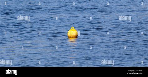 Yellow Floating Buoy Ball On Water Surface Marks Boundary Of Safe