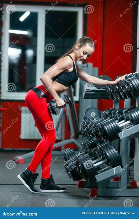 Full Length Photo Of Muscular Fitness Woman Lifting Dumbbells And