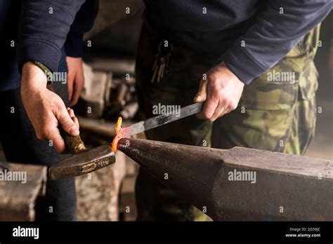 Blacksmith Forges Hinge On A Anvil Hammering Hot Red Steel Stock Photo Alamy