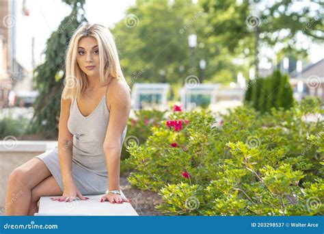 A Young Lovely Blonde Model Poses Outdoors While Enjoying A Summers Day