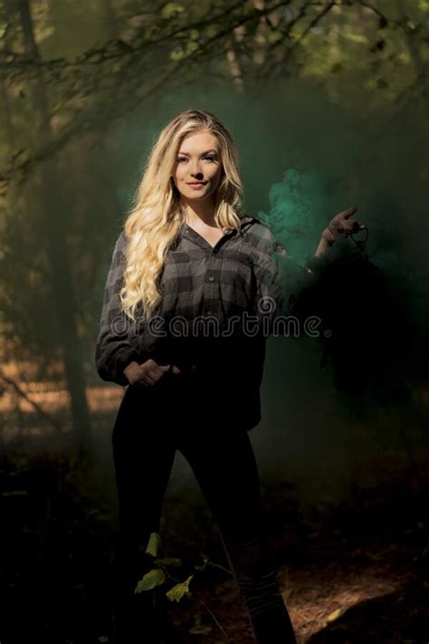 A Lovely Blonde Model Holds A Lantern With Smoke Flowing Out Of It In A