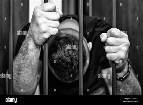 Abstract Hands Of The Prisoner On A Steel Lattice Close Up Prison