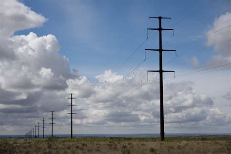 Row Of Utility Poles And And High Voltage Power Lines In A Rural