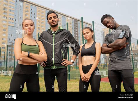 Young Sporty Men And Women In Activewear Standing In Urban Environment