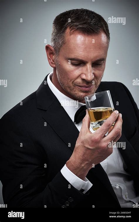 He Enjoys A Well Aged Scotch Portrait Of A Tuxedo Clad Mature Man