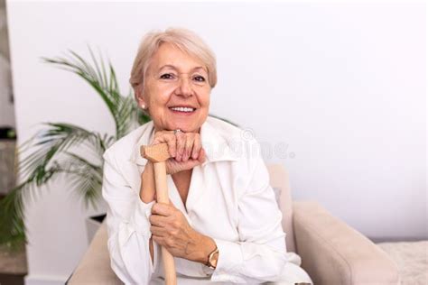 Portrait Of Beautiful Senior Woman With White Hair And Walking Stick