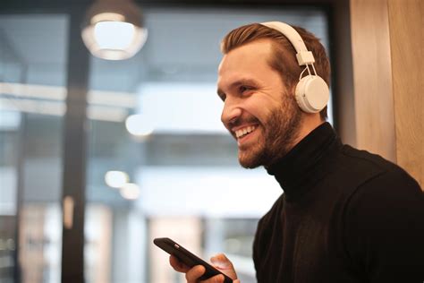 Free Photo Man Wearing White Headphones Listening To Music Bokeh