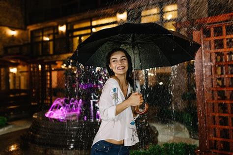 Premium Photo Cheerful Pretty Girl Holding Umbrella While Strolling