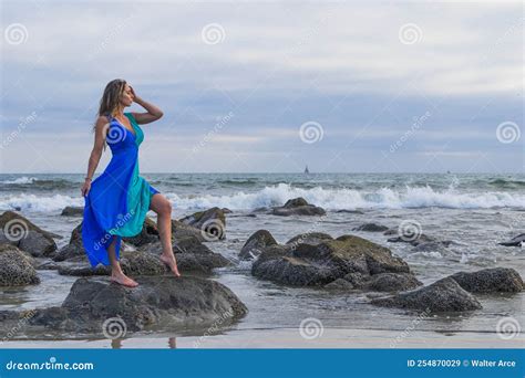 Lovely Brunette Latin Model Poses Outdoors On A Beach At Sunset Stock