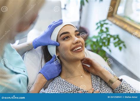 Masseur Giving Treatment To Beautiful Brunette Close Up Portrait Of A Young Beautiful Girl