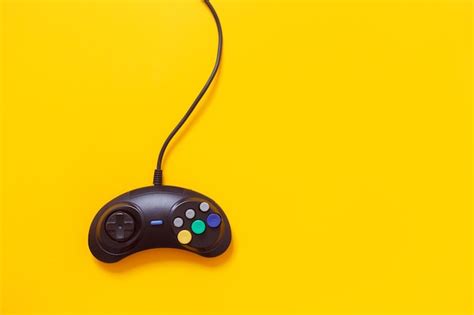 Premium Photo Black Wired Gamepad Isolated On Yellow Console Games