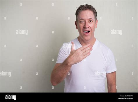 Portrait Of Mature Man With Gray Hair Against White Background Stock Photo Alamy