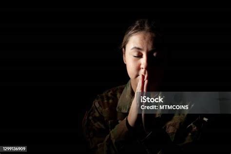 Dramatic Portrait Of Female Soldier Praying Stock Photo Download