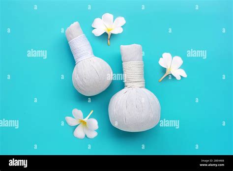 Plumeria Or Frangipani Flower With Herbal Compress Balls For Thai Massage And Spa Treatment On