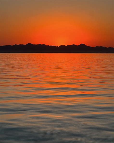 Sunset Over Water With Mountains