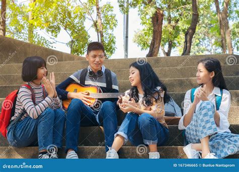 Group Of Child Student Playing Guitar And Singing Songs Together In