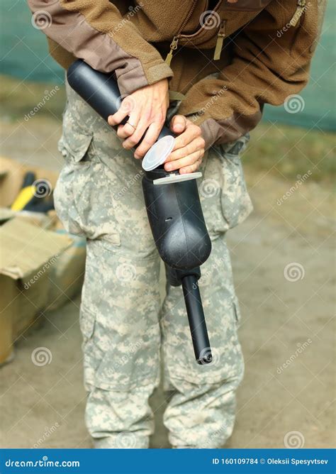 Man loading paintball gun stock photo. Image of hands - 160109784