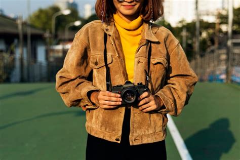 Premium Photo Girl Smiling While Holding A Camera