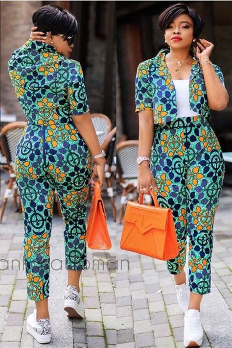 Two Women In Matching Outfits One Carrying An Orange Purse And The