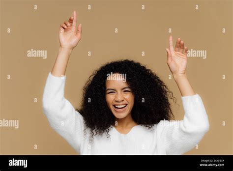 Horizontal Shot Of Lovely Dark Skinned Female Model Has Toothy Smile